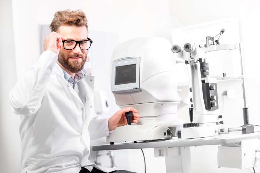 Eye doctor with ophthalmologic device stock photo